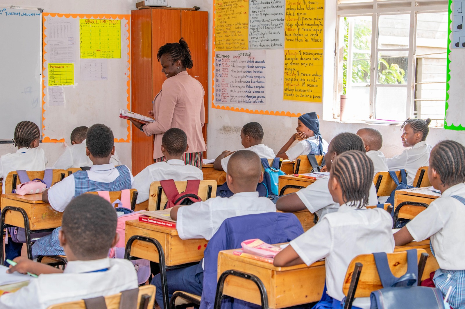 Learners engaged in a classroom lesson with their teacher