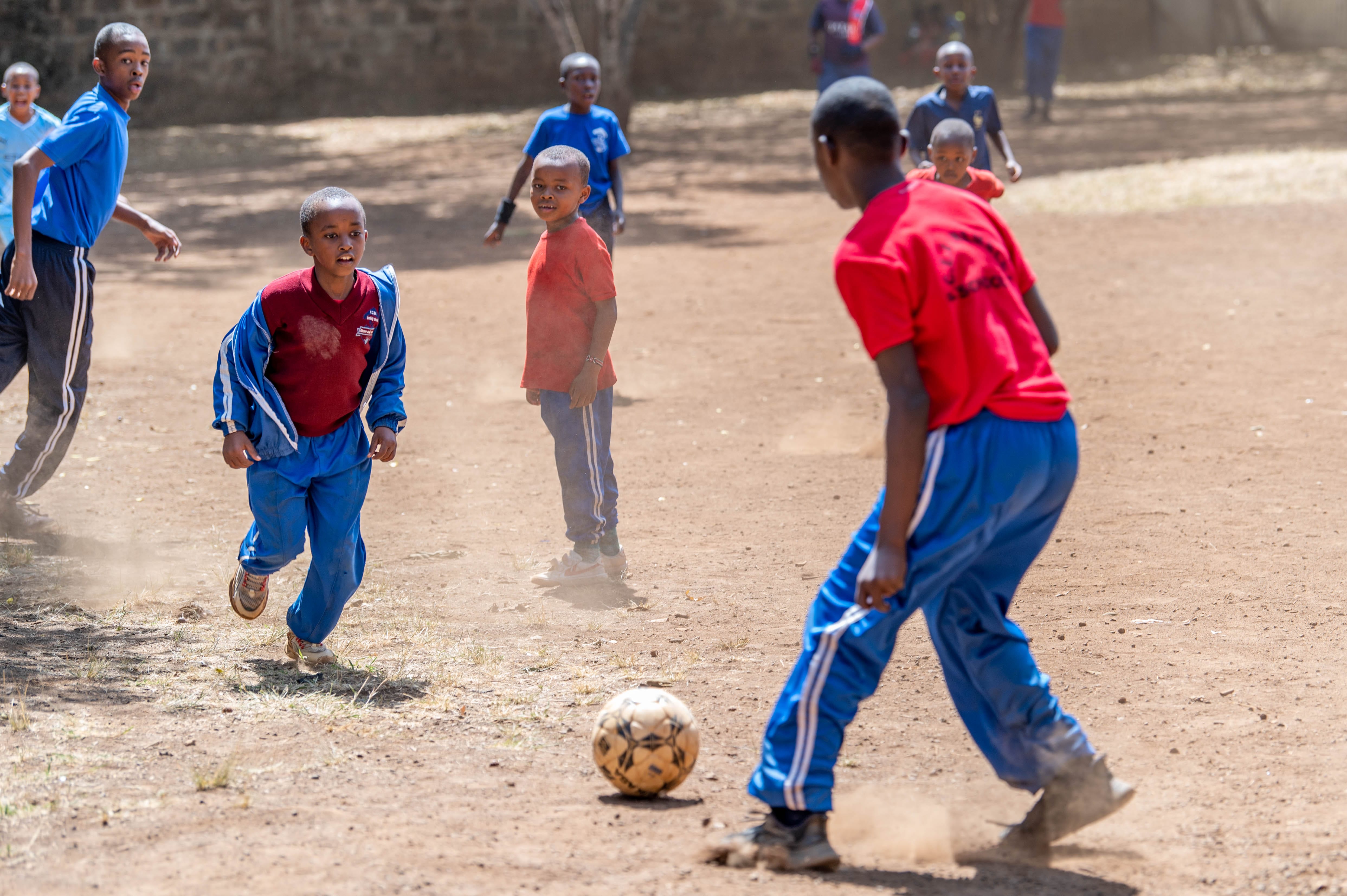 Pupils playing football on the school field