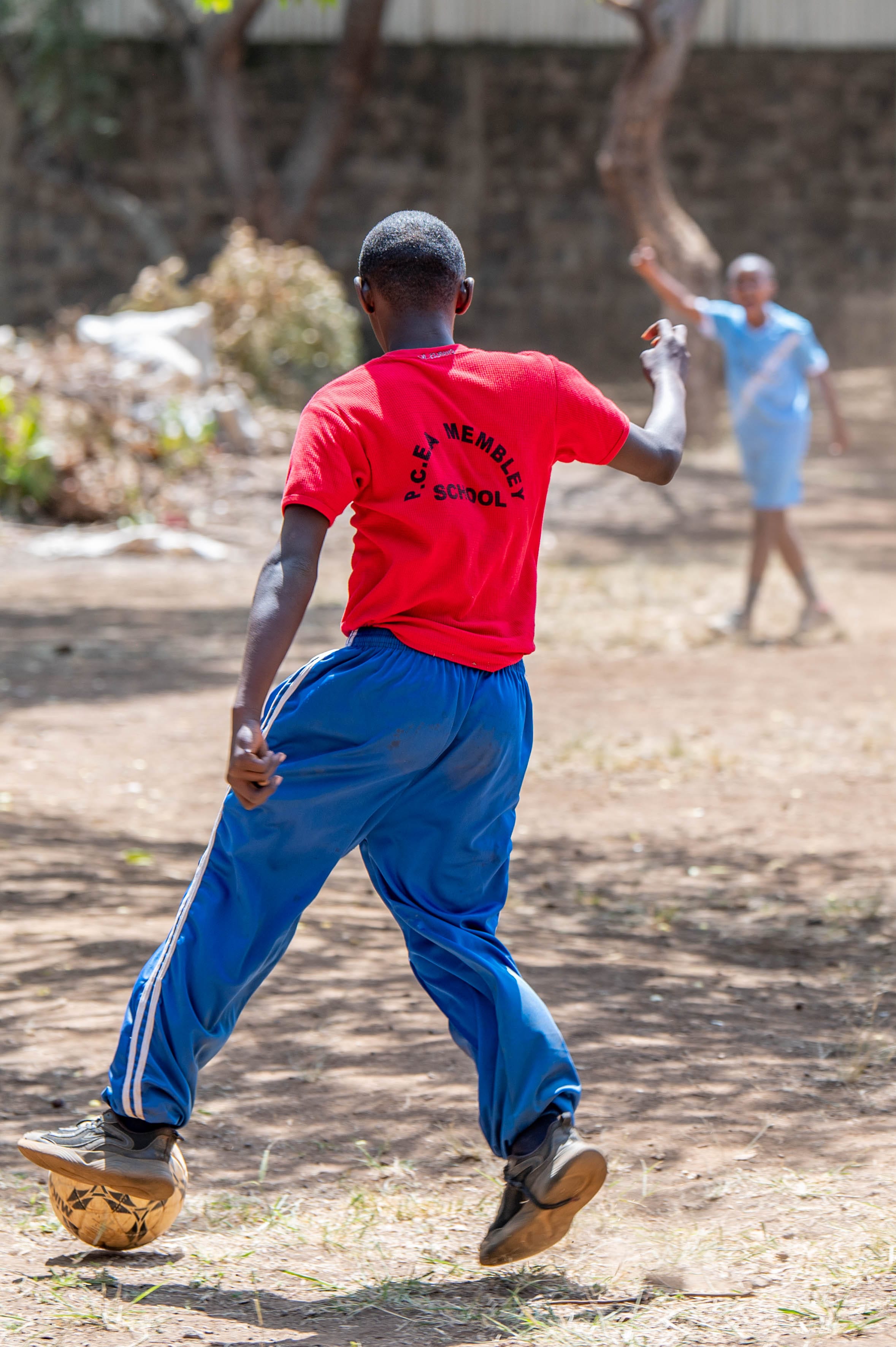 Learners practicing football skills in team play