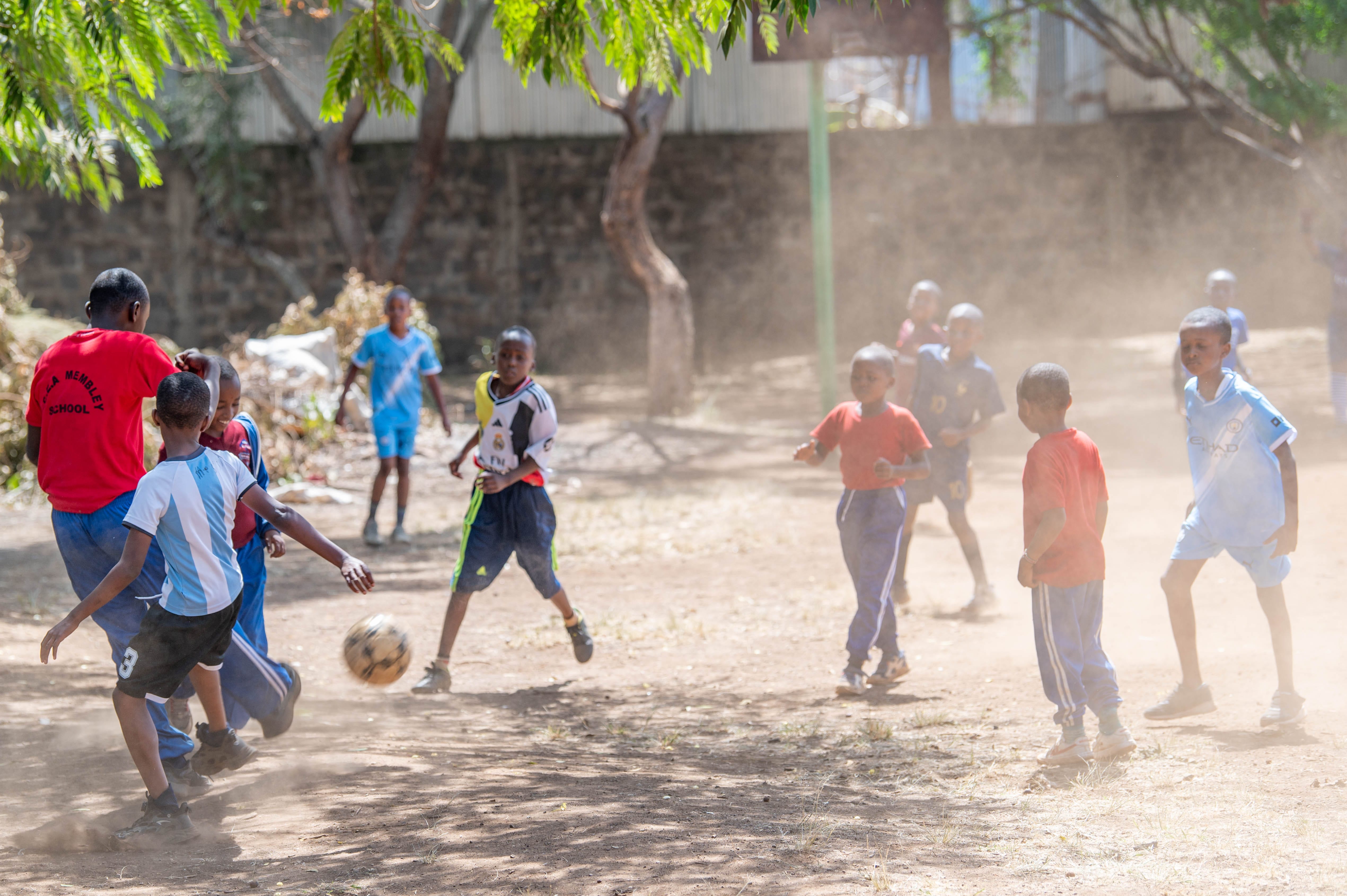 Pupils actively engaged in a sports game outdoors