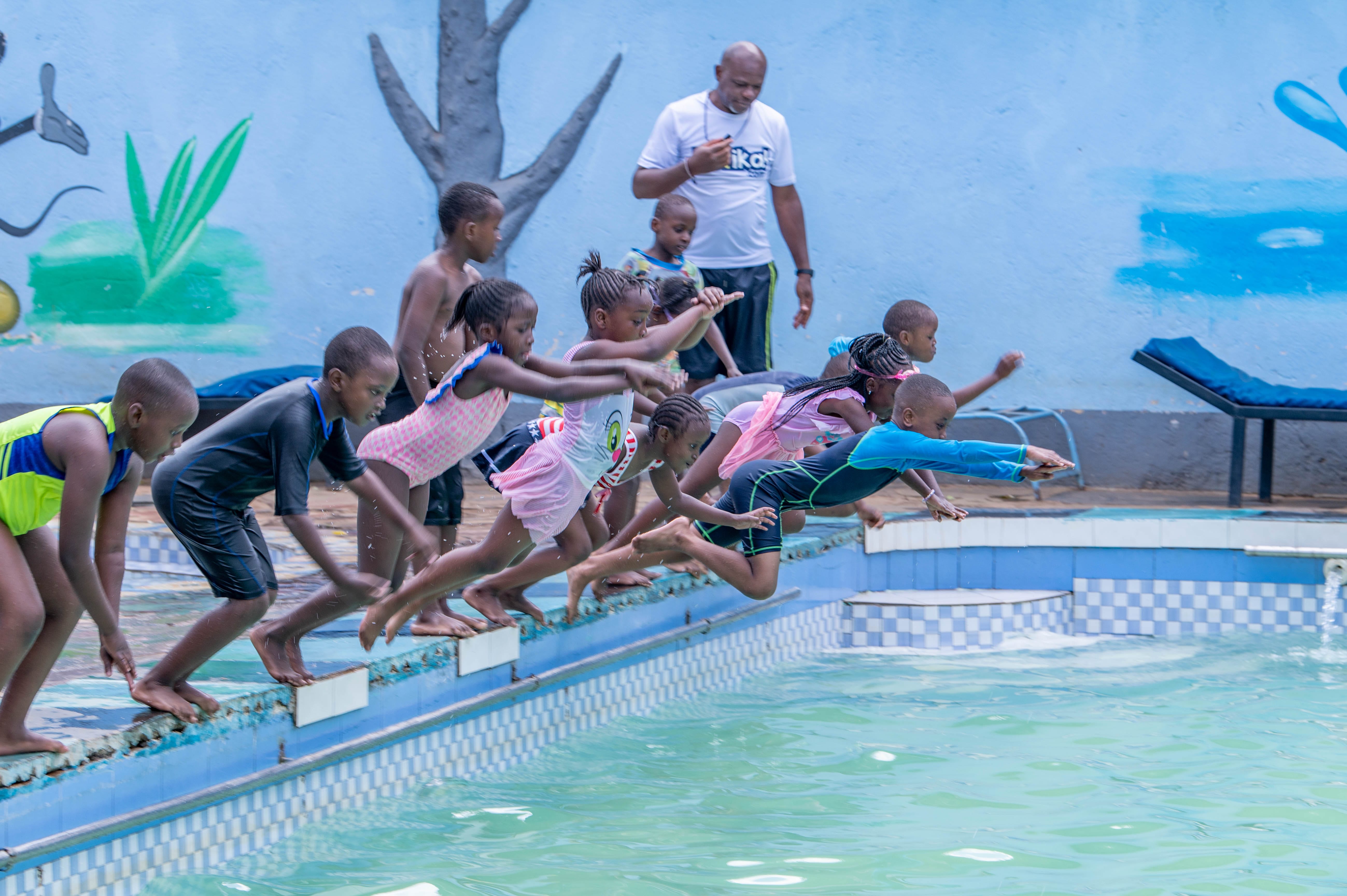 Children enjoying guided swimming practice in the pool